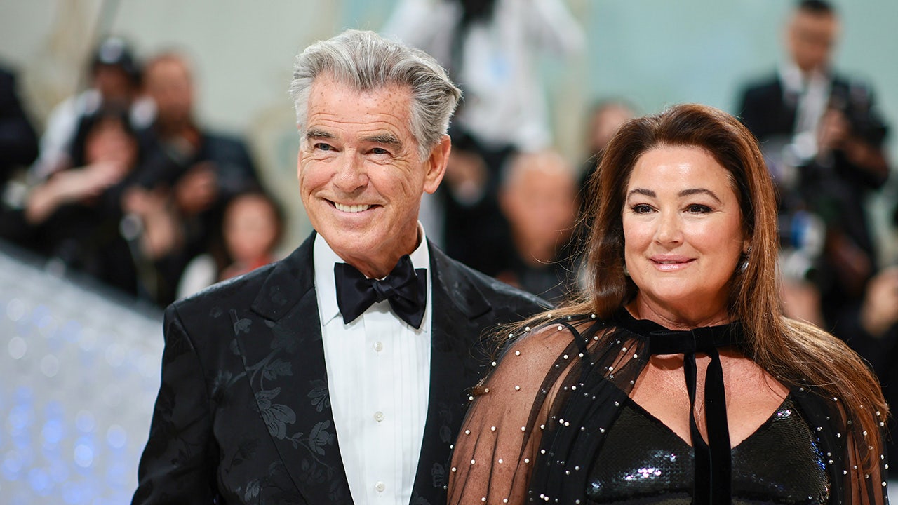Pierce Brosnan et Keeley Shaye Smith marchant main dans la main